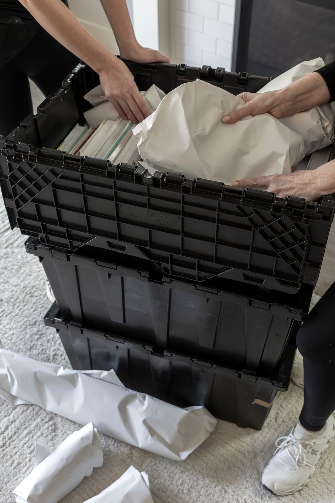 A B. Moore Moving team member nesting paper-wrapped belongings into a protective moving crate