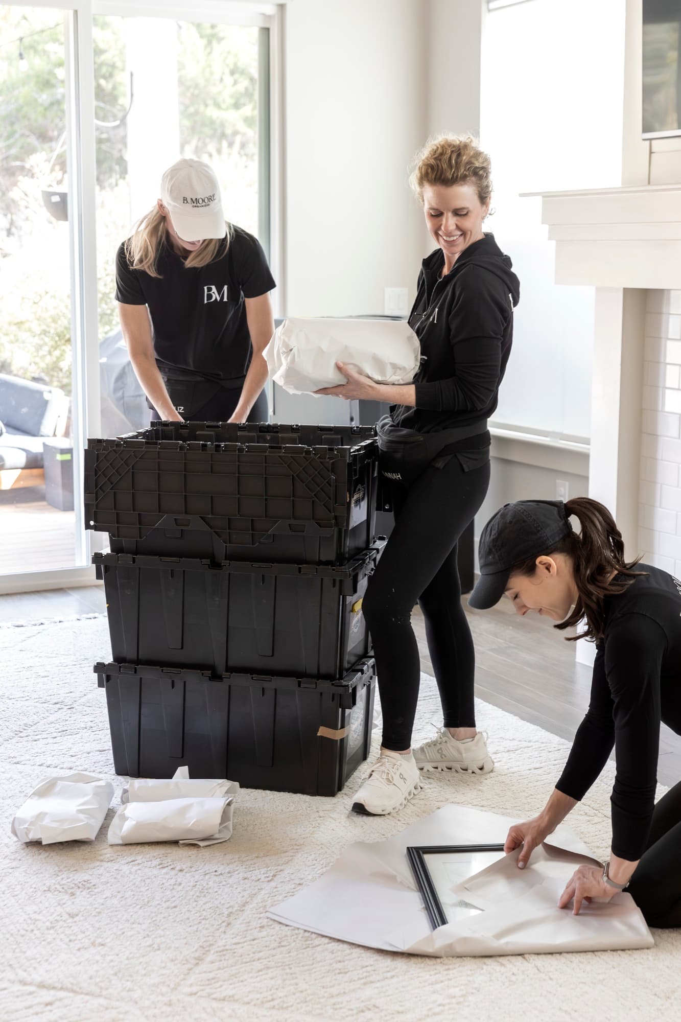 The B. Moore crew wrapping and crating a client's belongings in a light-filled Austin home