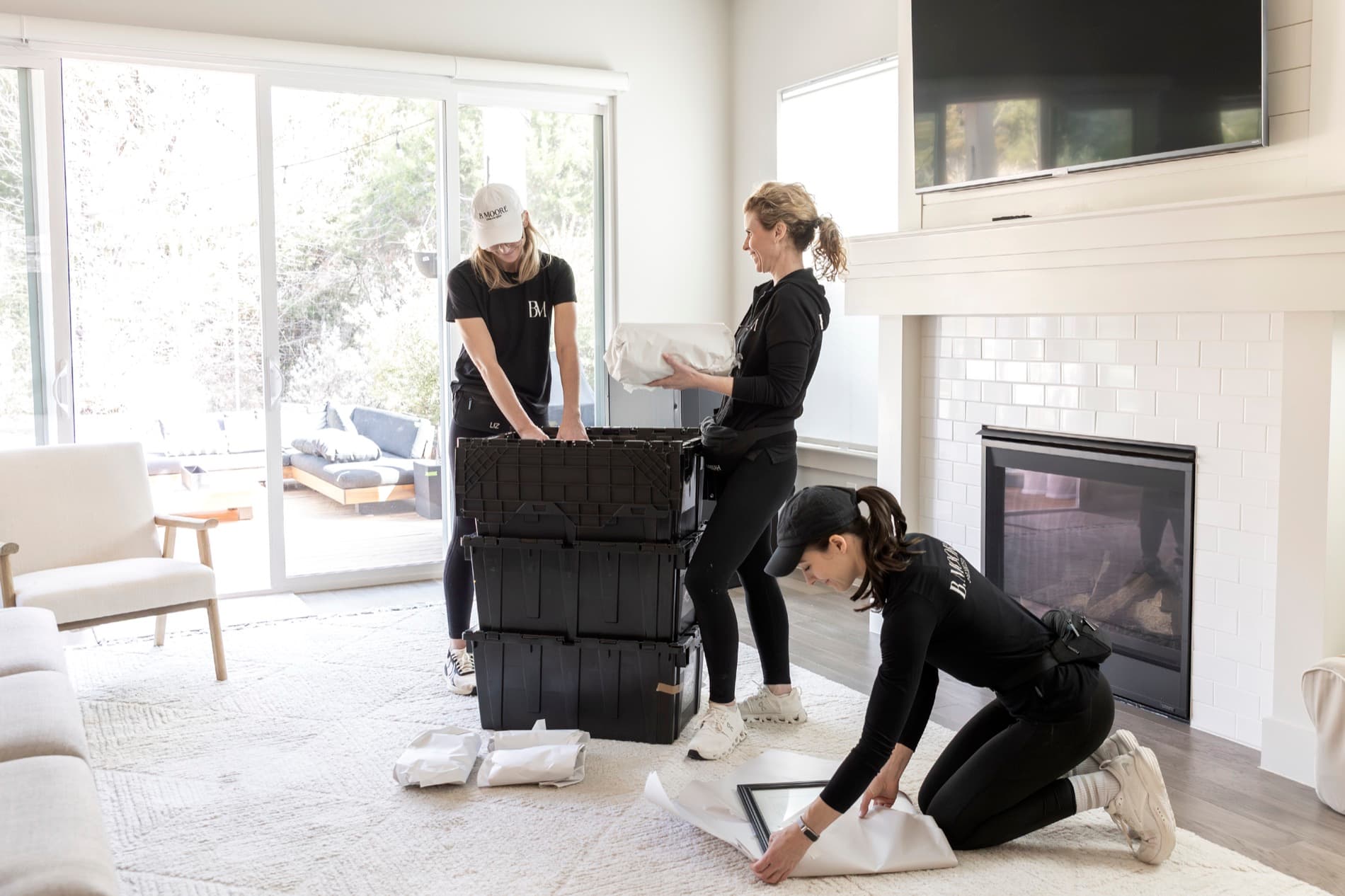 The B. Moore Moving crew sorting and protecting belongings in a bright Austin living room