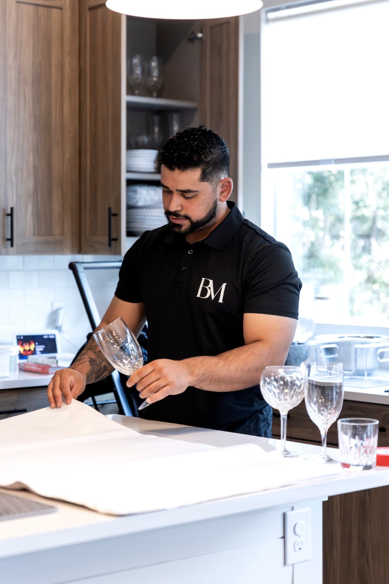 A B. Moore Moving team member hand-wrapping a crystal glass in packing paper
