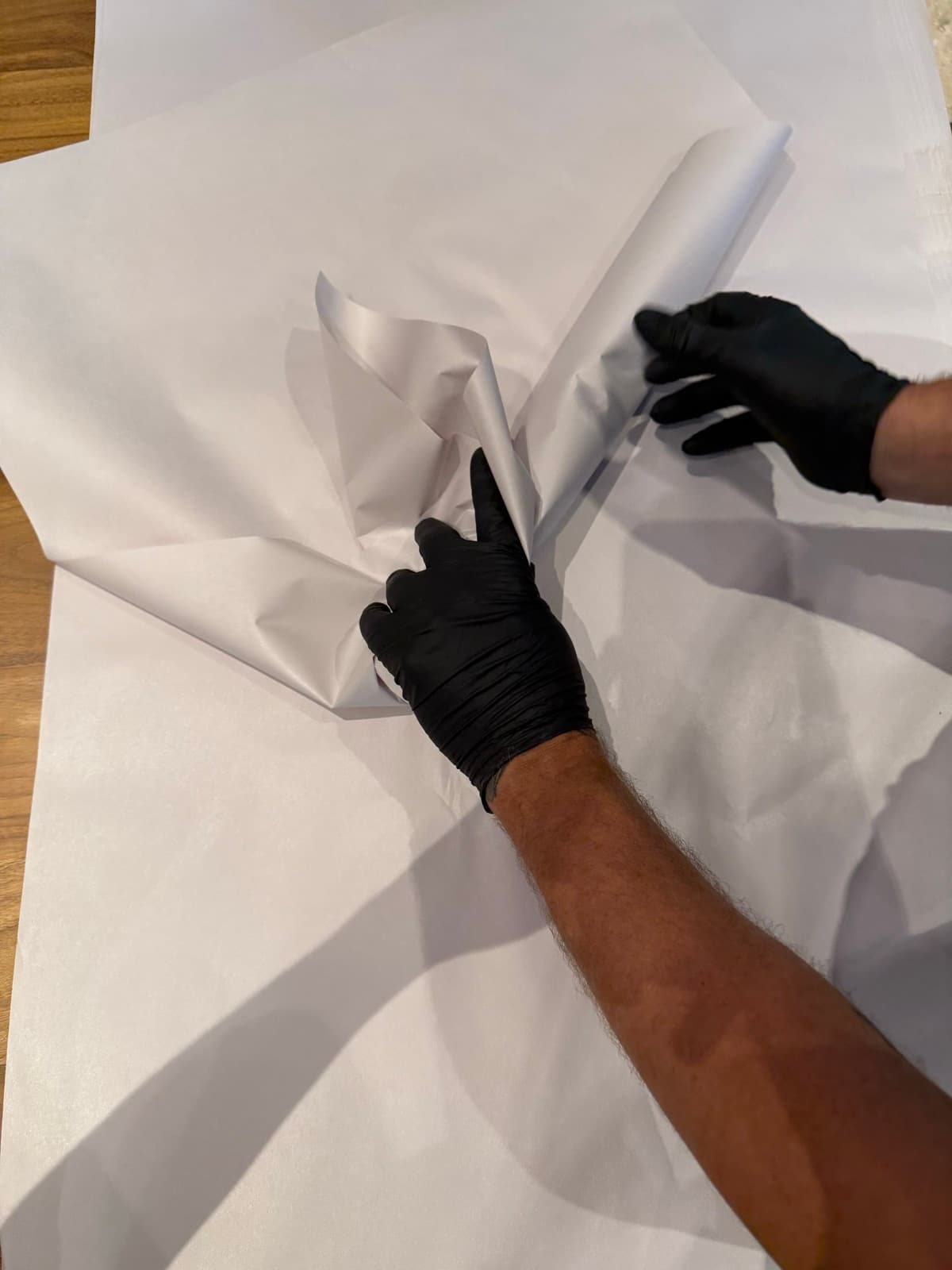A B. Moore crew member carefully packing a fragile item